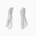 A pair of 14K White Gold Diamond Crossover Hoop Earrings featuring two intertwined, diamond-encrusted lines on each hoop, displayed against a plain white background.