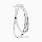 A pair of 14K White Gold Diamond Crossover Hoop Earrings featuring two intertwined, diamond-encrusted lines on each hoop, displayed against a plain white background.