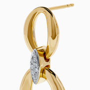 These 14K Yellow Gold Diamond Accented Double Drop Earrings feature oval and circular hoops linked by a marquise-shaped diamond cluster for a dazzling finish.