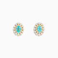 A pair of 18K Yellow Gold Paraiba and Diamond Stud Earrings featuring an oval Paraiba gemstone at the center, surrounded by a halo of small clear diamonds, displayed on a white background.