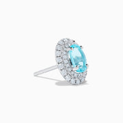 18K White Gold Paraiba and Diamond Stud Earrings featuring oval blue Paraiba center stones, each encircled by a halo of sparkling diamonds, set against a white background.