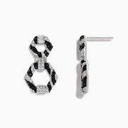 Showcased on a white background, these 14k White Gold Black and White Diamond Zebra Print Earrings feature alternating black and silver hexagonal segments encrusted with sparkling stones.