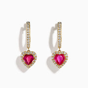 14K Yellow Gold Pink Sapphire and Diamond Heart Dangle Earrings, featuring heart-shaped pink sapphires with diamond halos and diamond-accented hooks, elegantly displayed on a white background.