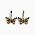 14K Yellow Gold Black and White Diamond Butterfly Earrings featuring a hoop design and geometric crystal pattern on the wings, shown against a white background.