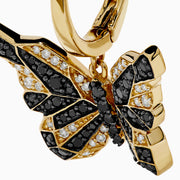 14K Yellow Gold Black and White Diamond Butterfly Earrings featuring a hoop design and geometric crystal pattern on the wings, shown against a white background.