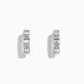 A pair of Classique 14K White Gold Diamond Hoop Earrings, featuring rectangular and round clear gemstones, shown on a white background with soft shadows to the left of each earring.