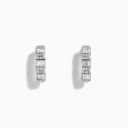 A pair of Classique 14K White Gold Diamond Hoop Earrings, featuring rectangular and round clear gemstones, shown on a white background with soft shadows to the left of each earring.