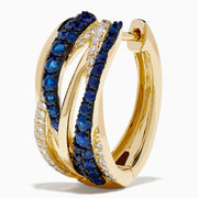 The 14K Yellow Gold Sapphire and Diamond Crossover Hoop Earrings feature intertwined bands set with blue sapphires and small clear diamonds, shown against a white background.