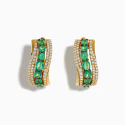 The 14K Yellow Gold Emerald and Diamond Hoop Earrings feature two rows of white diamonds, a central row of oval green gemstones, and a wavy design—ideal for fans of elegant emerald hoops.