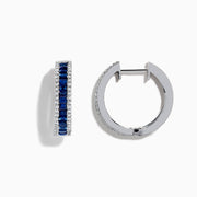 The Royale Bleu 14K White Gold Blue Sapphire and Diamond Hoop Earrings feature a central row of rectangular blue sapphires bordered by round white diamonds, displayed on a white background.