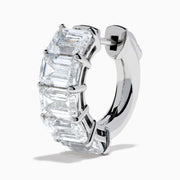A pair of Lab Grown Emerald Cut Diamond Huggie Earrings in 14K white gold, each featuring three vertically-set rectangular clear stones, is displayed against a plain white background.