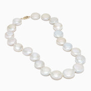 A close-up of the 14K Yellow Gold Freshwater Coin Shape Pearl Necklace, showcasing round, iridescent pearls in a partial semicircle on a white background.