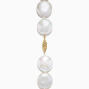 A close-up of the 14K Yellow Gold Freshwater Coin Shape Pearl Necklace, showcasing round, iridescent pearls in a partial semicircle on a white background.