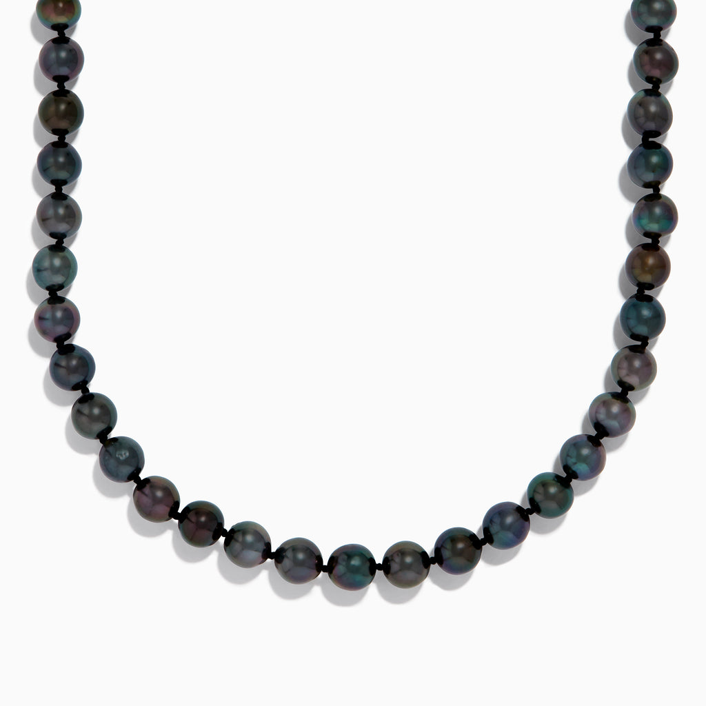 Close-up of the lower half of a 14K White Gold Tahitian Pearl Necklace, featuring round, dark pearls against a white background.