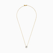 The Star Lab Grown Diamond Halo Pendant in 18K Yellow Gold features a round brilliant lab diamond surrounded by smaller diamonds on a gold chain, displayed against a plain white background.