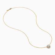 The Star Lab Grown Diamond Halo Pendant in 18K Yellow Gold features a round brilliant lab diamond surrounded by smaller diamonds on a gold chain, displayed against a plain white background.