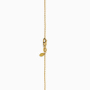 The Star Lab Grown Diamond Halo Pendant in 18K Yellow Gold features a round brilliant lab diamond surrounded by smaller diamonds on a gold chain, displayed against a plain white background.