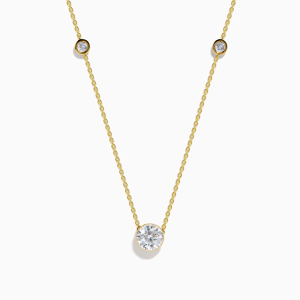 The Star Lab Grown Diamond Necklace in 18K Yellow Gold features a delicate chain with three round, bezel-set diamonds—a larger center diamond and two smaller diamonds evenly spaced along the chain.
