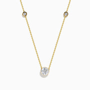 The Star Lab Grown Diamond Necklace in 18K Yellow Gold features a delicate chain with three round, bezel-set diamonds—a larger center diamond and two smaller diamonds evenly spaced along the chain.