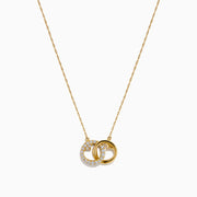 14K Yellow Gold Diamond Accented Interlocking Hearts Necklace featuring two entwined hearts—one with sparkling diamonds, the other polished smooth—shown on a plain white background.