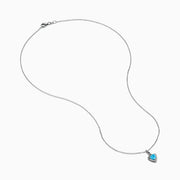 A 925 Sterling Silver Blue Topaz and Diamond Pendant, featuring a triangular blue topaz surrounded by sparkling diamonds, displayed on a white background.