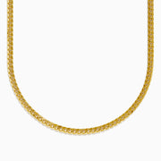 The 14K Yellow Gold Cuban Chain 22 features a flat, tightly linked design and is displayed in a curved U-shape against a plain white background.