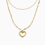 Two gold necklaces are shown: a delicate 14K yellow gold chain and the 14K Yellow Gold Stamp Heart Layered Paperclip Necklace, which features larger links and a heart-shaped pendant. Both pieces are displayed on a plain white background.