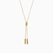 The 14K Yellow Gold Lariat Box Chain Necklace showcases a box-shaped slider at the center and two slender rectangular pendants on adjustable chains, all set against a plain white background.
