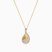 The 14K Yellow Gold Scattered Diamond Pendant features a teardrop-shaped diamond pendant partially encrusted with scattered diamonds, suspended from a delicate gold chain against a white background.