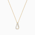 The DOro 14K Yellow Gold Diamond Pendant features a teardrop-shaped diamond accented with sparkling white stones, hanging on a delicate gold chain and set against a plain white background.