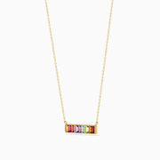 The Mosaic 14K Yellow Gold Multi Color Gemstone and Diamond Collar Bone Bar Necklace features a horizontal bar pendant set with five baguette-cut rainbow gemstones: red, purple, blue, green, and yellow.