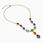 The Mosaic 14K Yellow Gold Diamond and Multi Color Gemstone Statement Necklace showcases four large oval gemstones—blue, green, orange, and purple—each encircled by diamonds in a vertical design on a white background.