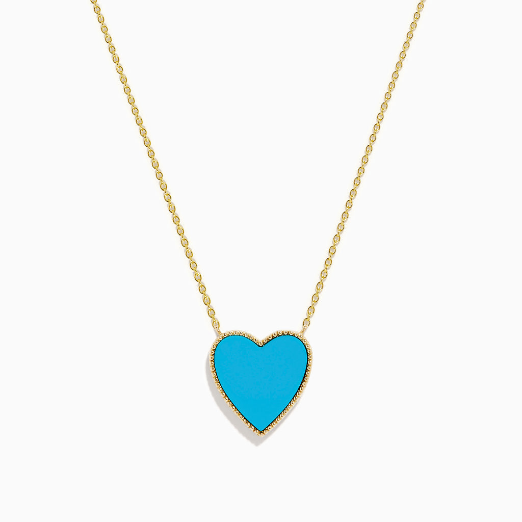 The 14K Gold Turquoise and Diamond Reversible Heart Necklace showcases a bold turquoise heart pendant framed in gold, displayed on a white background.