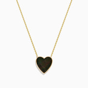The 14K Gold Black Mother of Pearl and Diamond Reversible Heart Necklace features a heart-shaped black mother of pearl pendant bordered in gold.