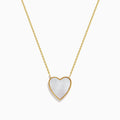 14K Gold Mother of Pearl and Diamond Reversible Heart Necklace featuring a large heart-shaped pendant with gold detailing, shown on a plain white background.