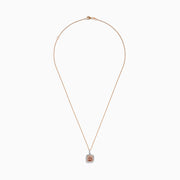 The 14K Two Tone Gold Morganite and Diamond Pendant features a cushion-cut peach morganite surrounded by sparkling diamonds, set in a blend of rose and white gold for an elegant, refined look.