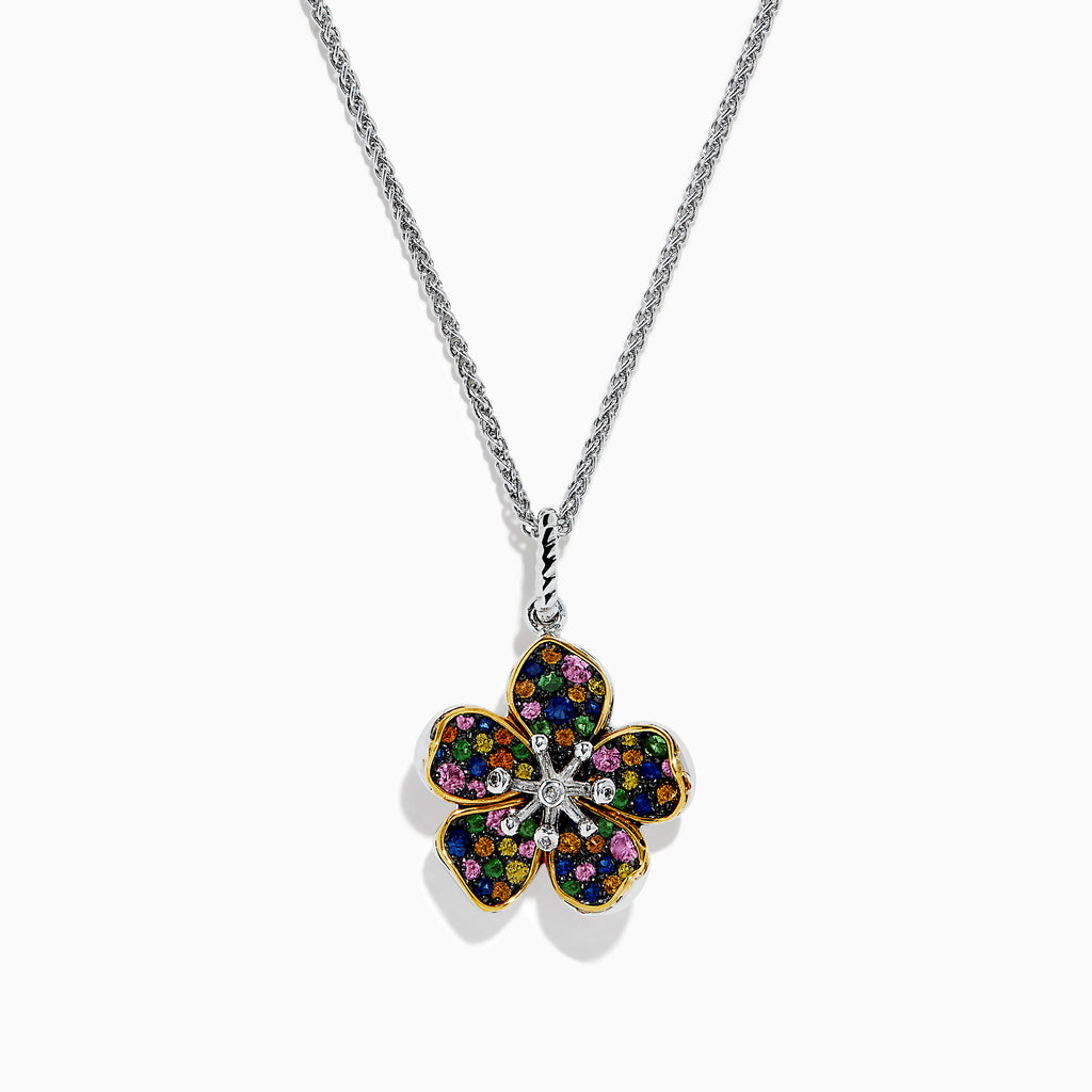 The Splash Sterling Silver Diamond, Sapphires & Tsavorite Flower Necklace features a silver chain with a flower pendant edged in gold, adorned with vibrant sapphires and tsavorite on each petal, and a sparkling diamond at the center.