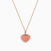 The 14K Rose Gold Pink Opal and Diamond Heart Pendant features a pink opal heart accented with sparkling diamonds on a rose gold chain.