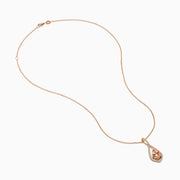 The Blush 14K Rose Gold Morganite and Diamond Pendant features a pear-shaped morganite framed by a halo of white diamonds on a delicate rose gold chain.