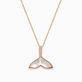 The Seaside 14K Gold Pendant features a whale’s tail design with mother-of-pearl inlay, sparkling diamonds on the bail, and a touch of quartz crystal for added elegance.