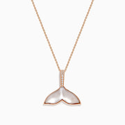 The Seaside 14K Gold Pendant features a whale’s tail design with mother-of-pearl inlay, sparkling diamonds on the bail, and a touch of quartz crystal for added elegance.