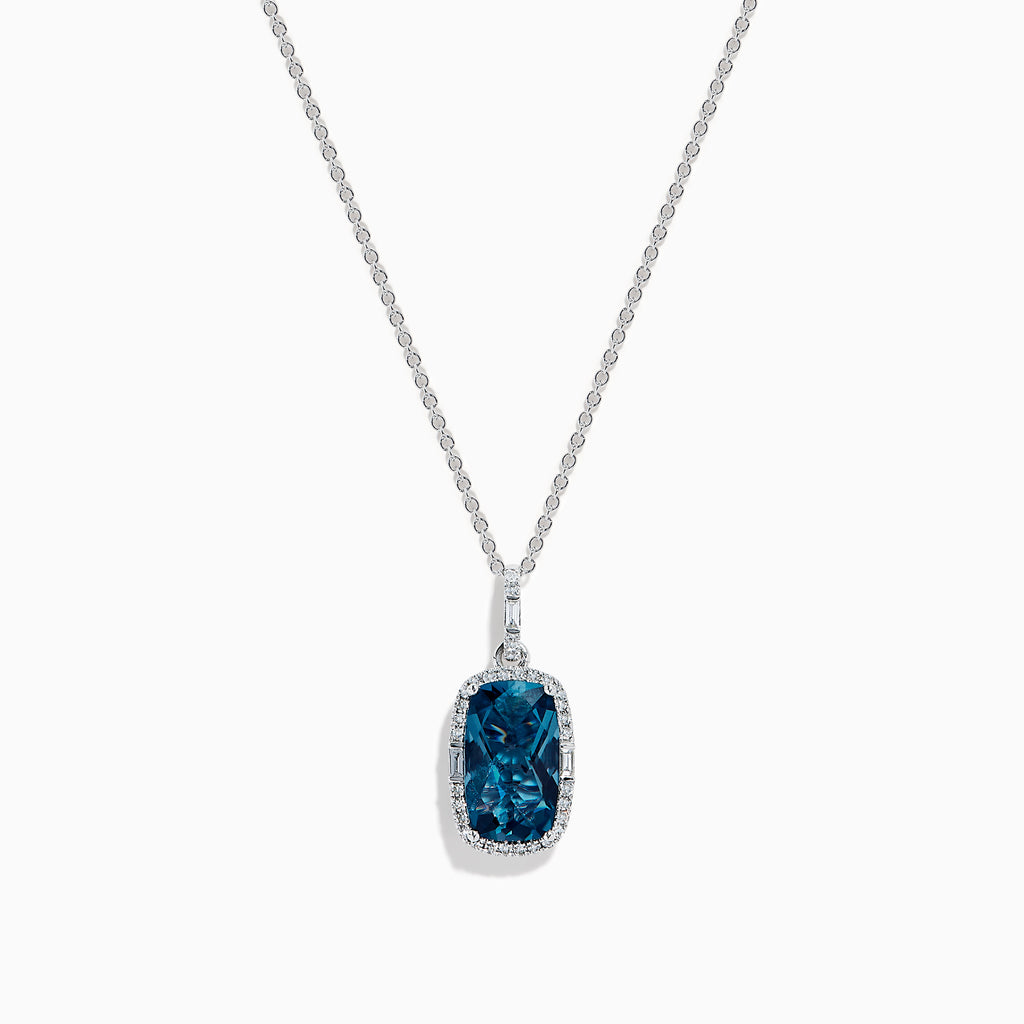 A 14 karat white gold necklace featuring an elongated cushion blue topaz and diamond pendant, set in an elegant frame.