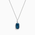 A 14 karat white gold necklace featuring an elongated cushion blue topaz and diamond pendant, set in an elegant frame.
