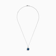 The Ocea Bleu 14K White Gold Blue Topaz and Diamond Pendant showcases a round blue topaz encircled by small diamonds, hanging from a delicate chain against a white background.