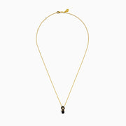 A delicate 14K yellow gold necklace features a flip flop pendant accented with onyx and diamonds, displayed against a white background.