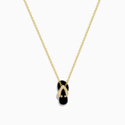 A delicate 14K yellow gold necklace features a flip flop pendant accented with onyx and diamonds, displayed against a white background.