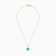 The Ocean Bleu 14K Yellow Gold Blue Topaz and Diamond Pendant features an oval blue topaz surrounded by sparkling diamonds on a gold chain, displayed against a white background.
