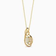 The Aurora 14K Yellow Gold Opal and Diamond Pendant features a teardrop opal encircled by sparkling diamonds on a delicate gold chain.