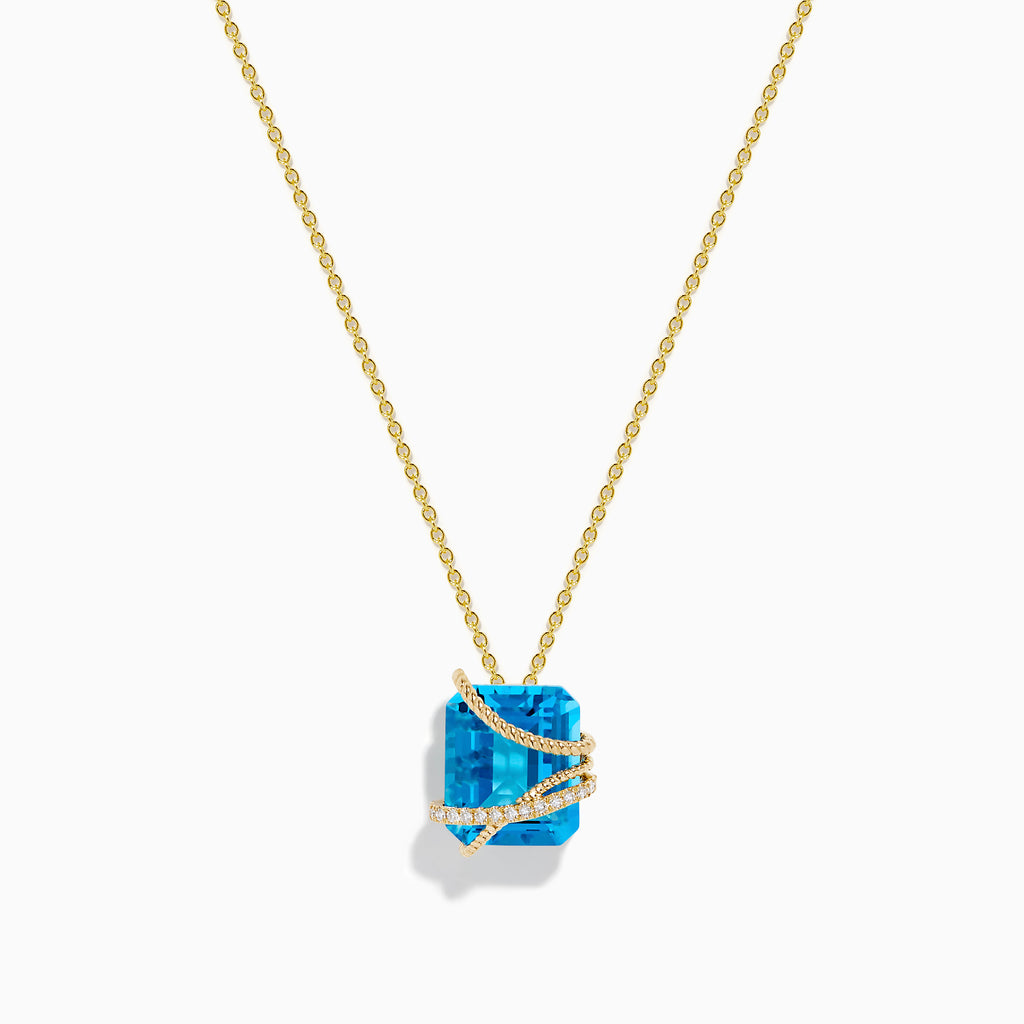 The Ocean Bleu 14K Yellow Gold Blue Topaz Pendant features a square-cut blue topaz wrapped in a diagonal gold band set with small white diamonds, displayed on a plain white background.