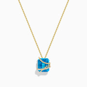The Ocean Bleu 14K Yellow Gold Blue Topaz Pendant features a square-cut blue topaz wrapped in a diagonal gold band set with small white diamonds, displayed on a plain white background.